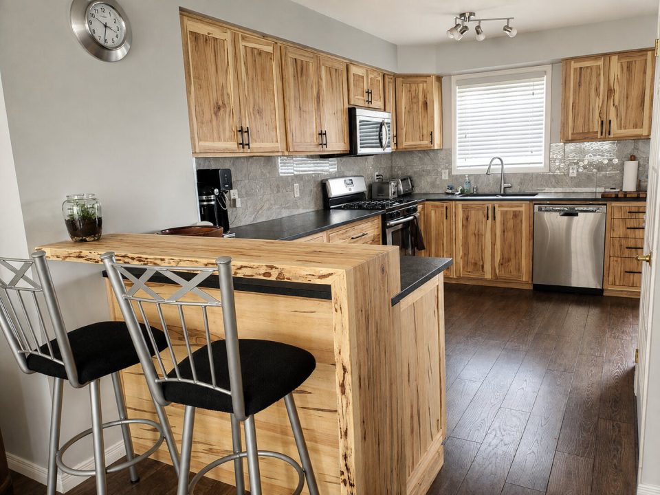 Ambrosia maple kitchen cabinetry with a live edge breakfast bar