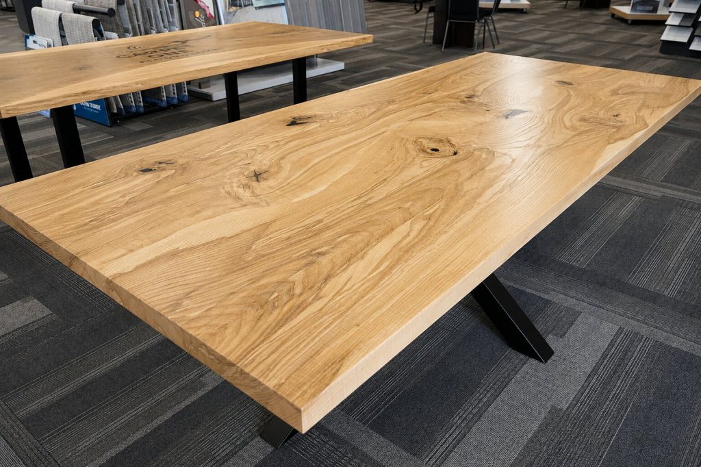 Curly white ash scribe laminated table top on a metal starburst pedestal base