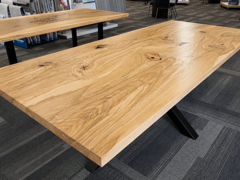 Curly white ash scribe laminated table top on a metal starburst pedestal base