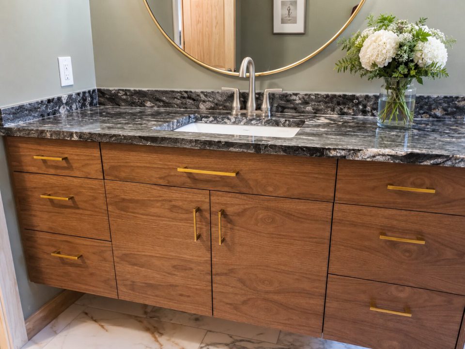 Floating vanity with grain matched walnut slab style doors and drawers