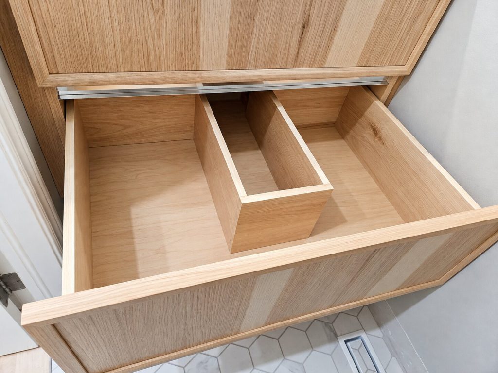 Interior notched dovetail drawers in a hickory vanity