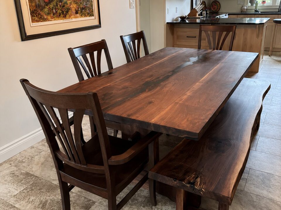 Live edge black walnut dining table with matching bench and chairs