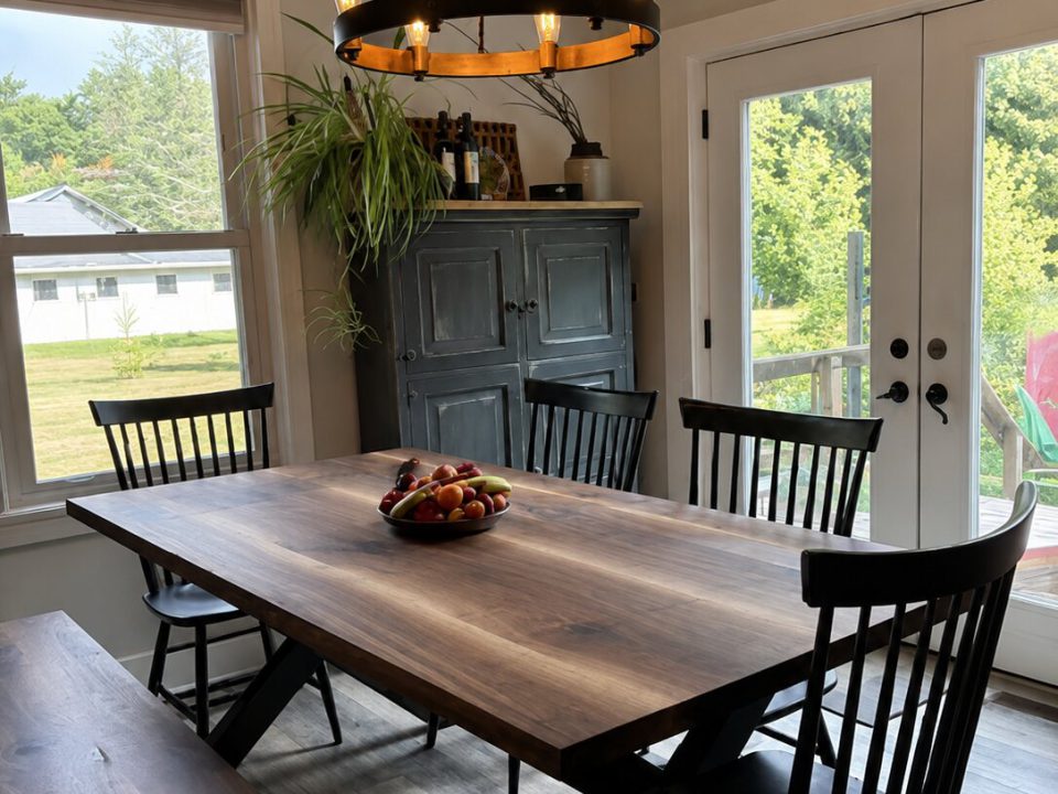 Natural walnut table with bookmatch laminated top and black painted wood X legs