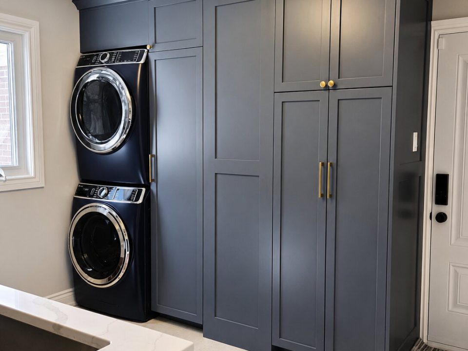 Ocean blue laundry room cabinets with integrated laundry hangers