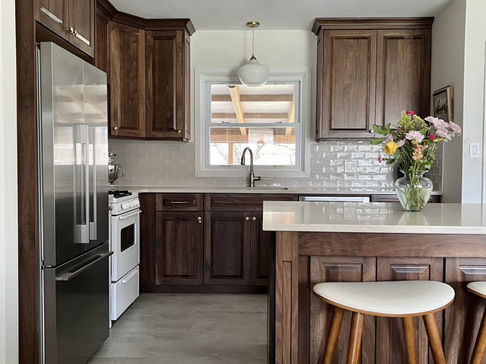 Raised panel walnut kitchen with cove crown moulding and eat-at island