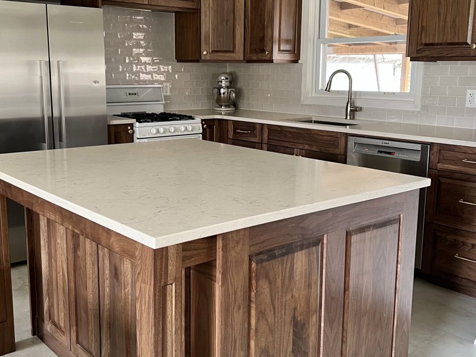 Raised panel walnut doors, cove crown moulding and eat-at island